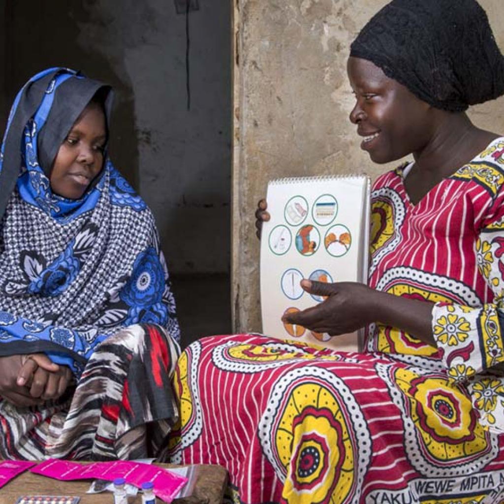 Photo credit: Community health worker during a home visit, providing family planning services and options to women in Uganda. (Jonathan Torgovnik/Getty Images/Images of Empowerment)